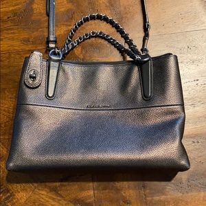 Coach handbag with leather cross body strap.